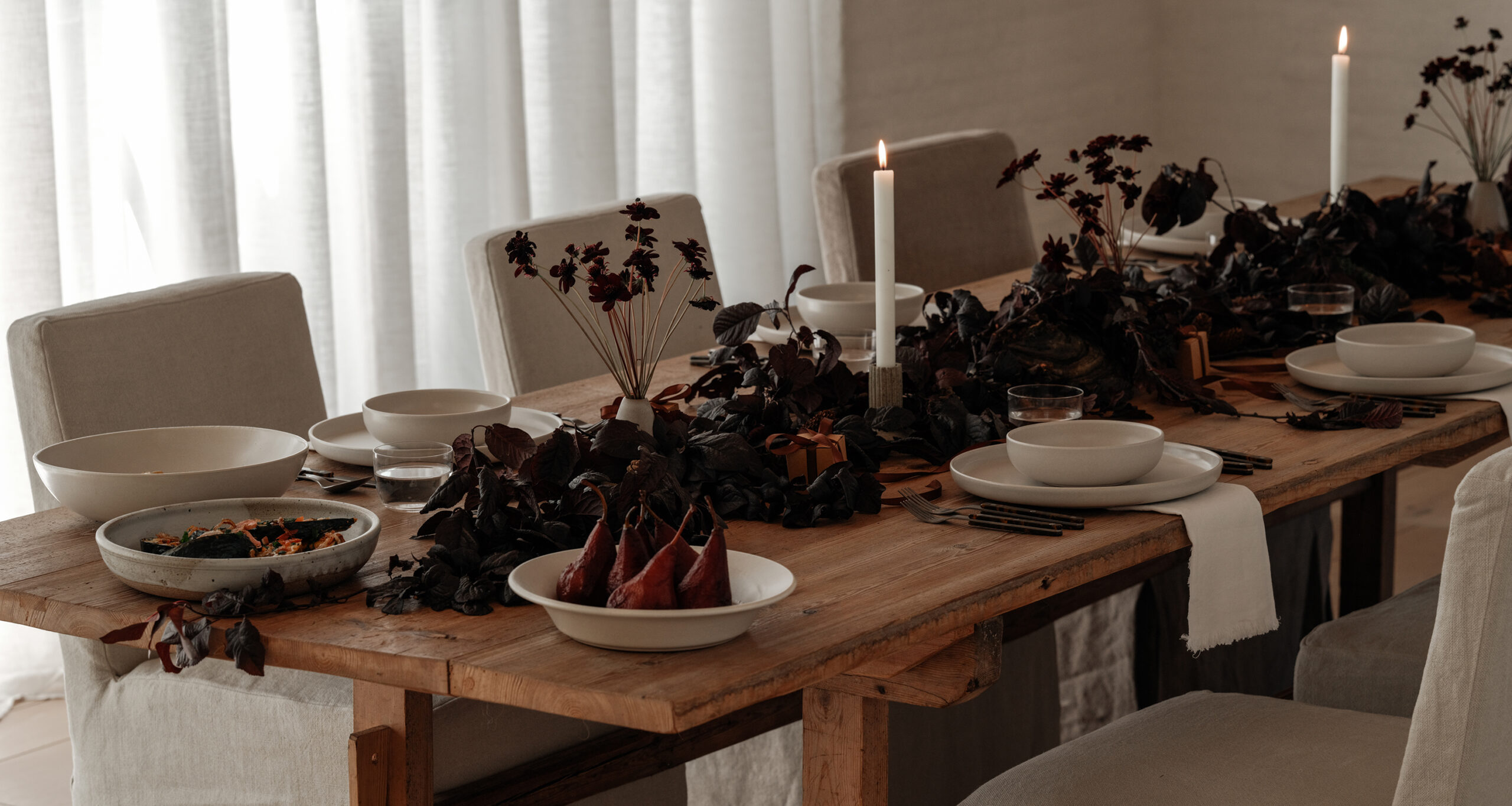holiday dinner table with dark florals and ivory plates