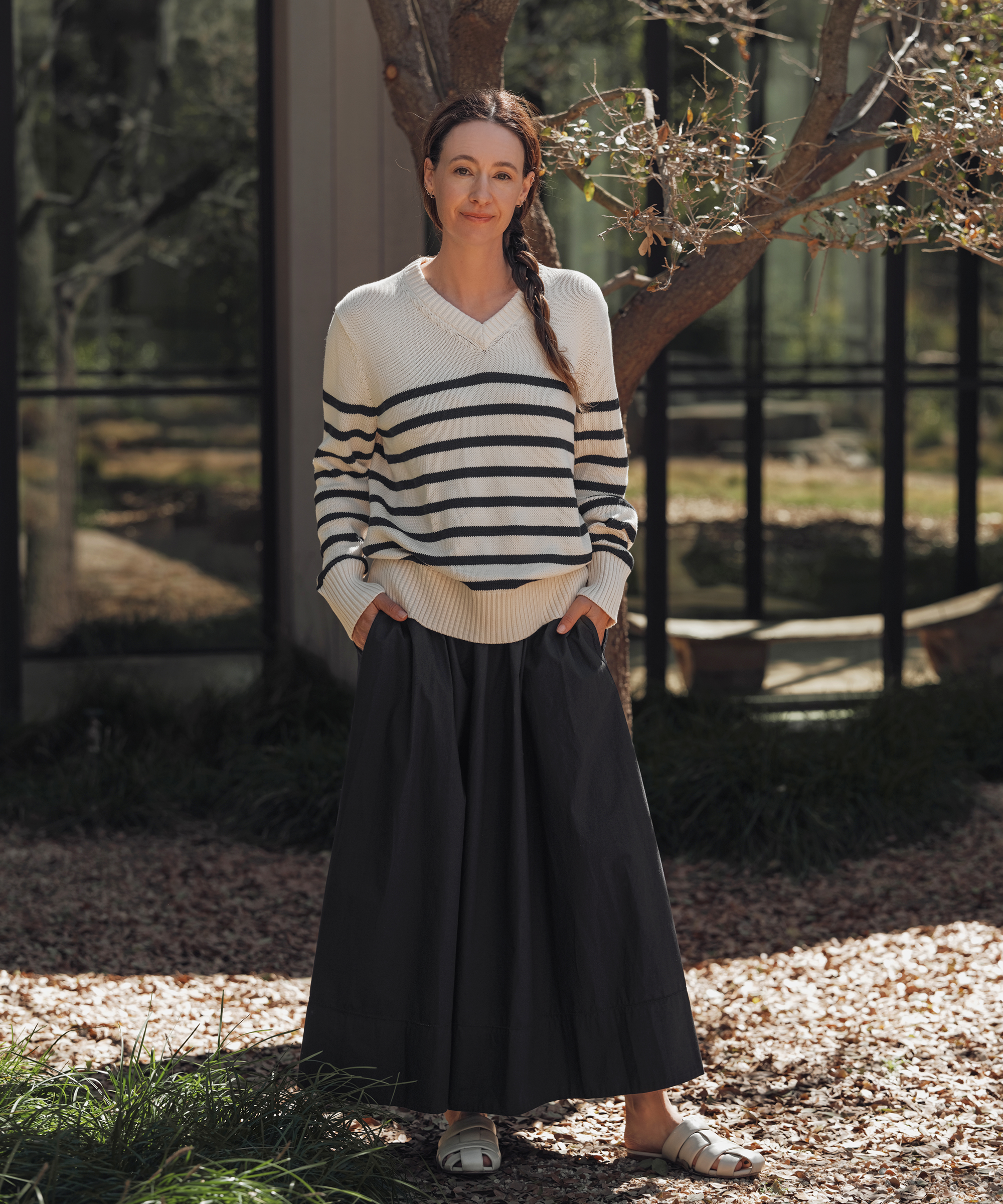 jenni wearing a cotton striped sweater and navy maxi skirt outdoors