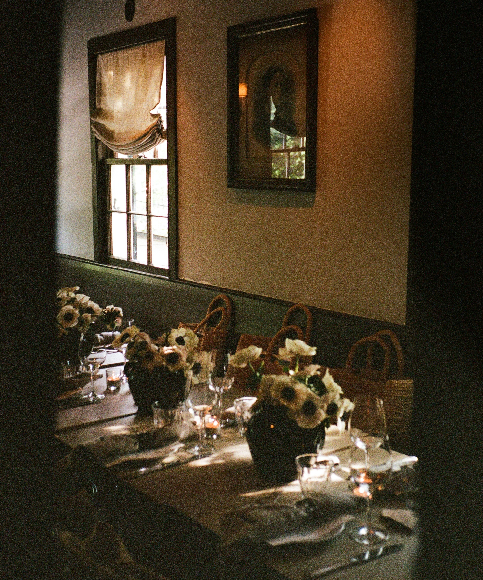 a dining table with moody florals and linen napkins