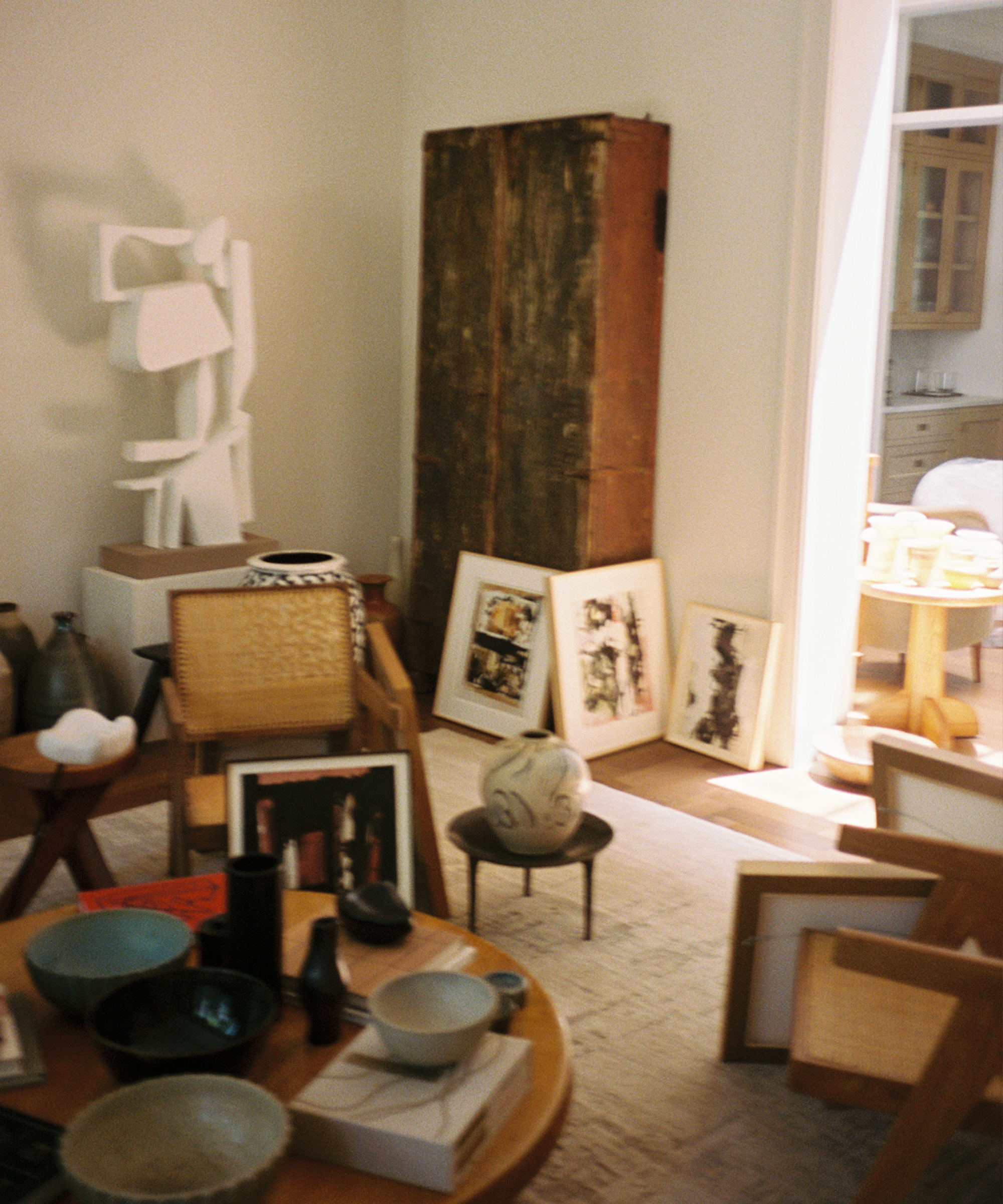 a gallery with wooden furniture and artwork and home decor