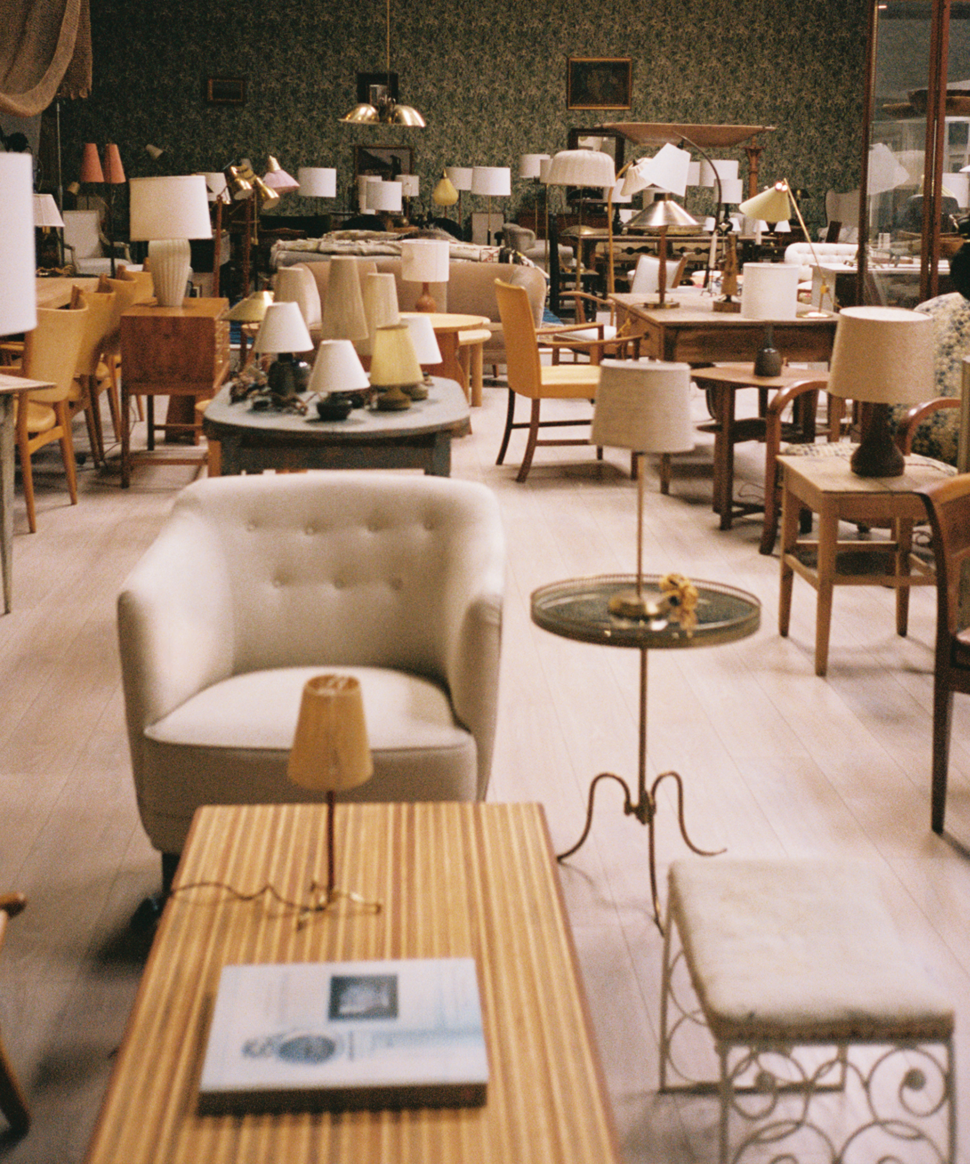 a howroom with tufted antique furniture and lamps with linen shades in various sizes
