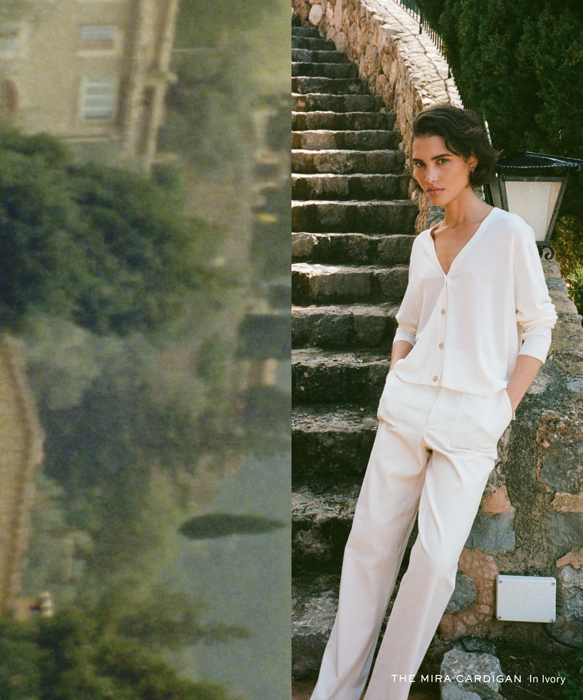A woman stands outdoors on stone steps, wearing an ivory cardigan and matching pants. Sunlight highlights her relaxed pose. The left side of the image shows a blurred, scenic background with greenery and buildings.