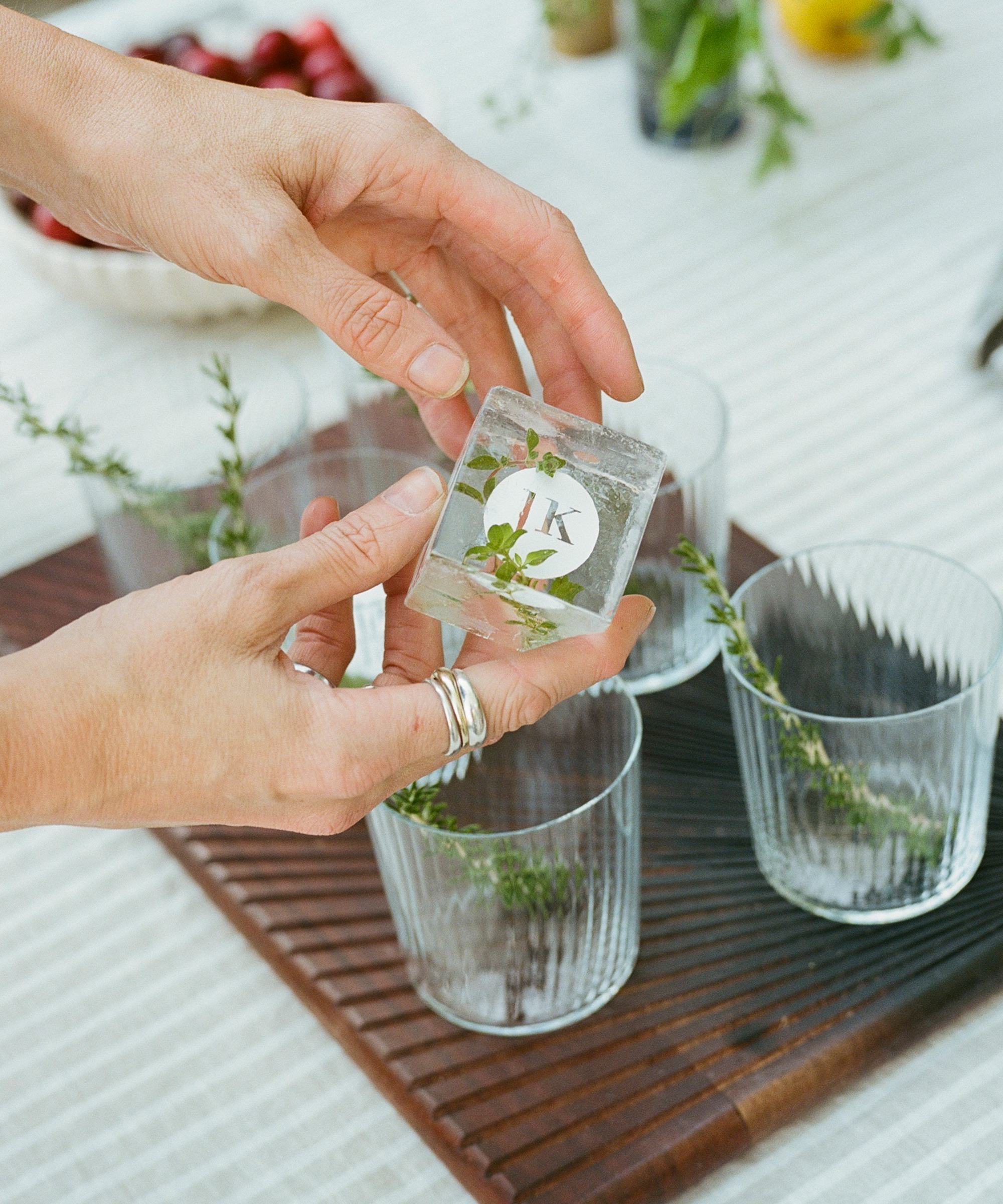 sqaure JK logo ice cubes for clear glasses on a wooden table with a linen tablecloth