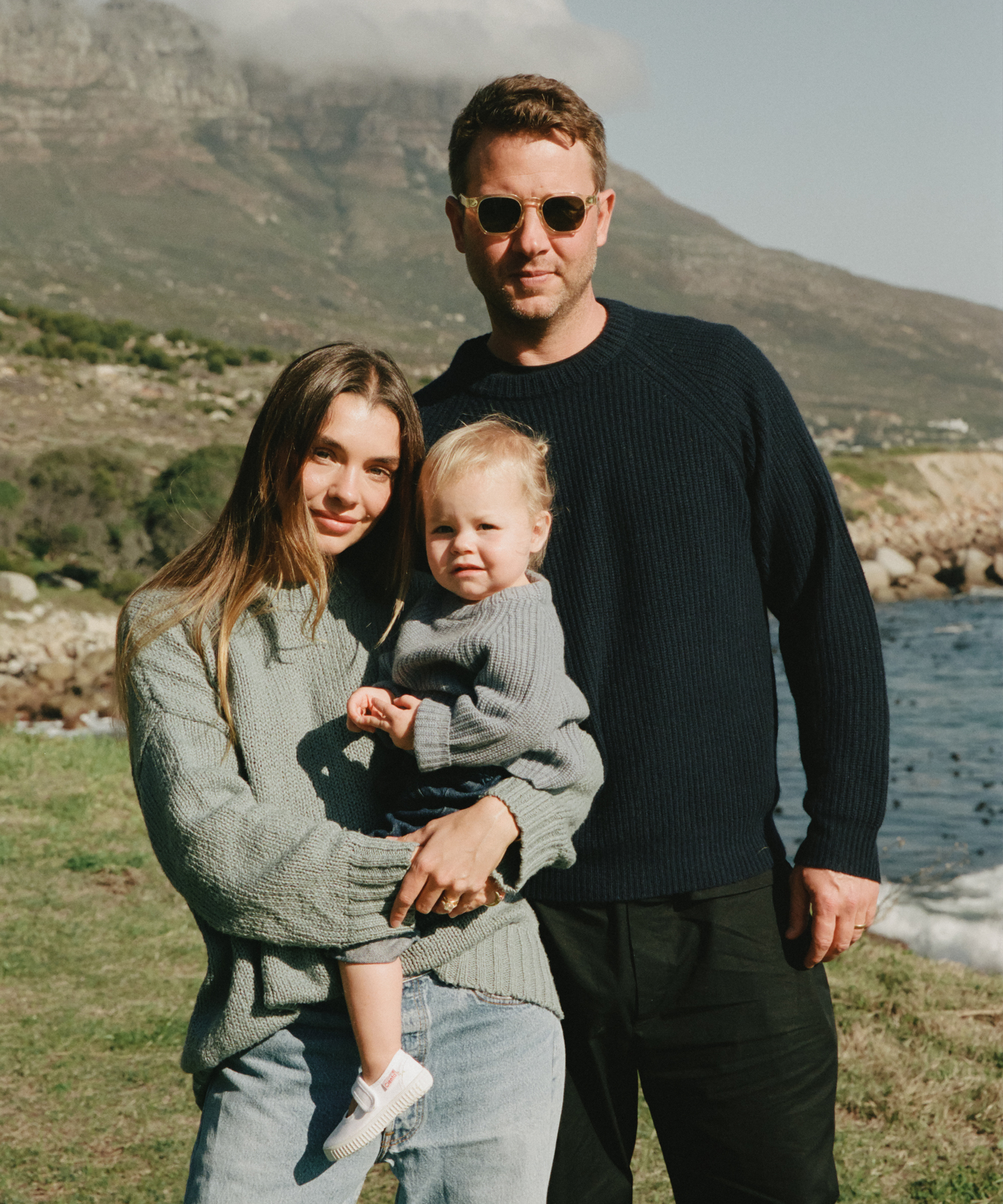 a family portrait wearing jenni kayne sweaters in front of a mountain in cape town