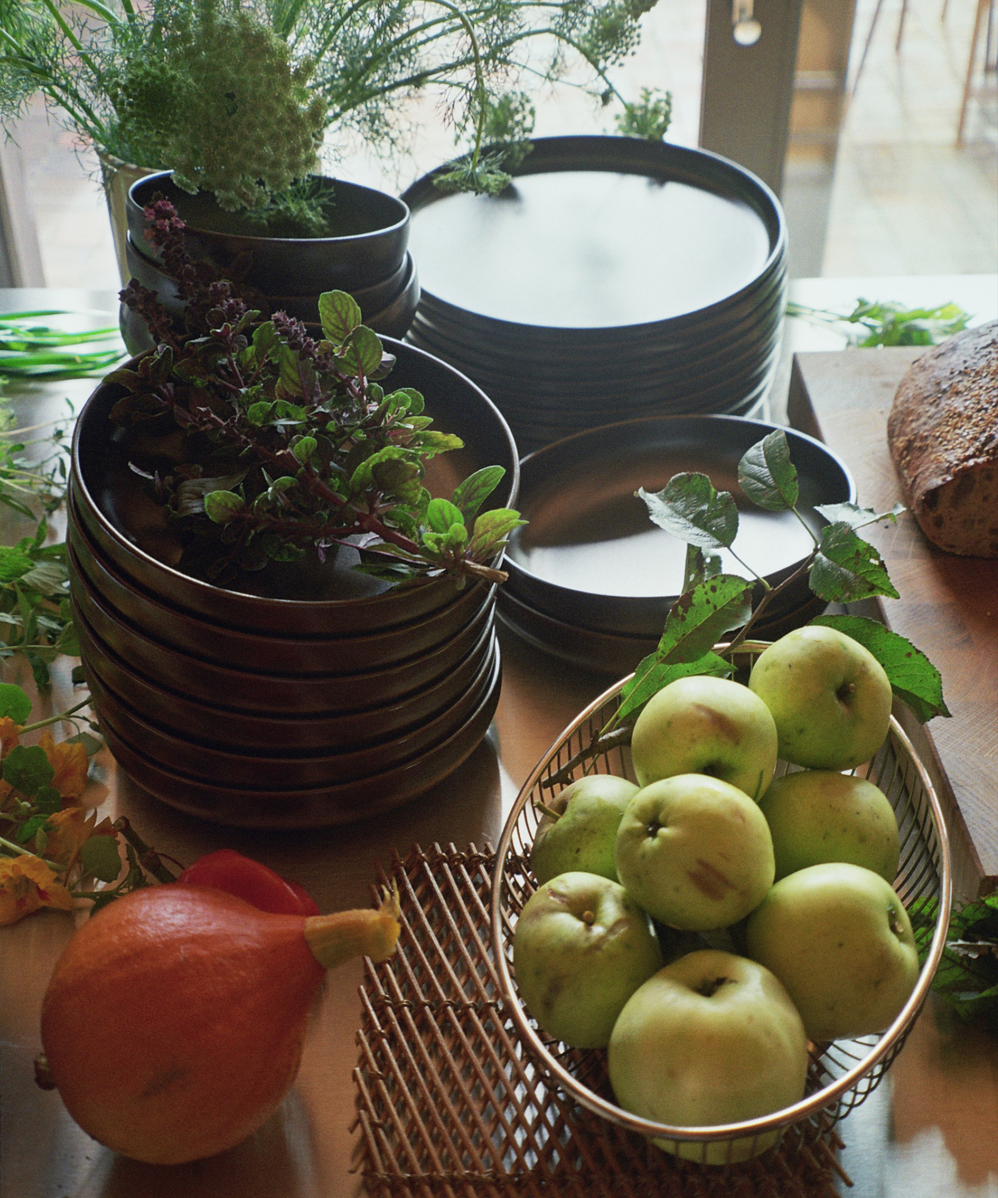 A stack of plates and bowls with fruits and vegetables.