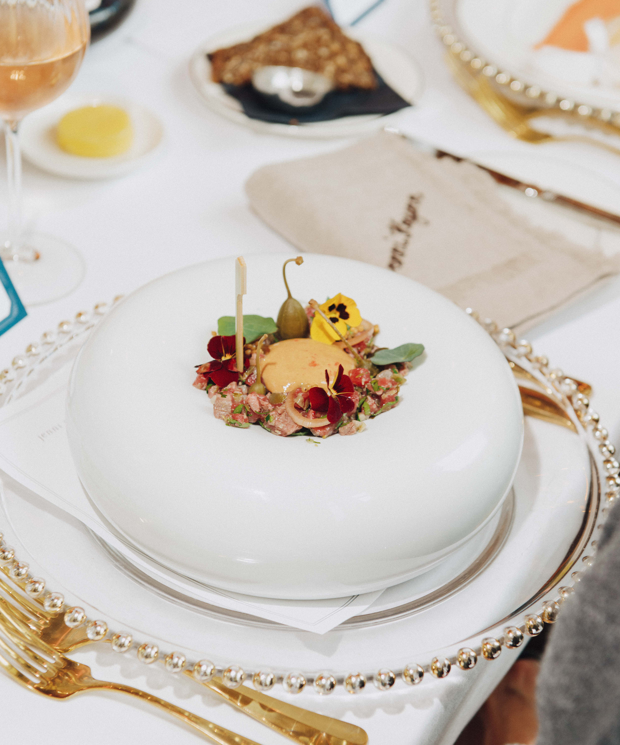 A white cake with flowers on top, perfect for celebrations or as a stunning centrepiece at Selfridges.