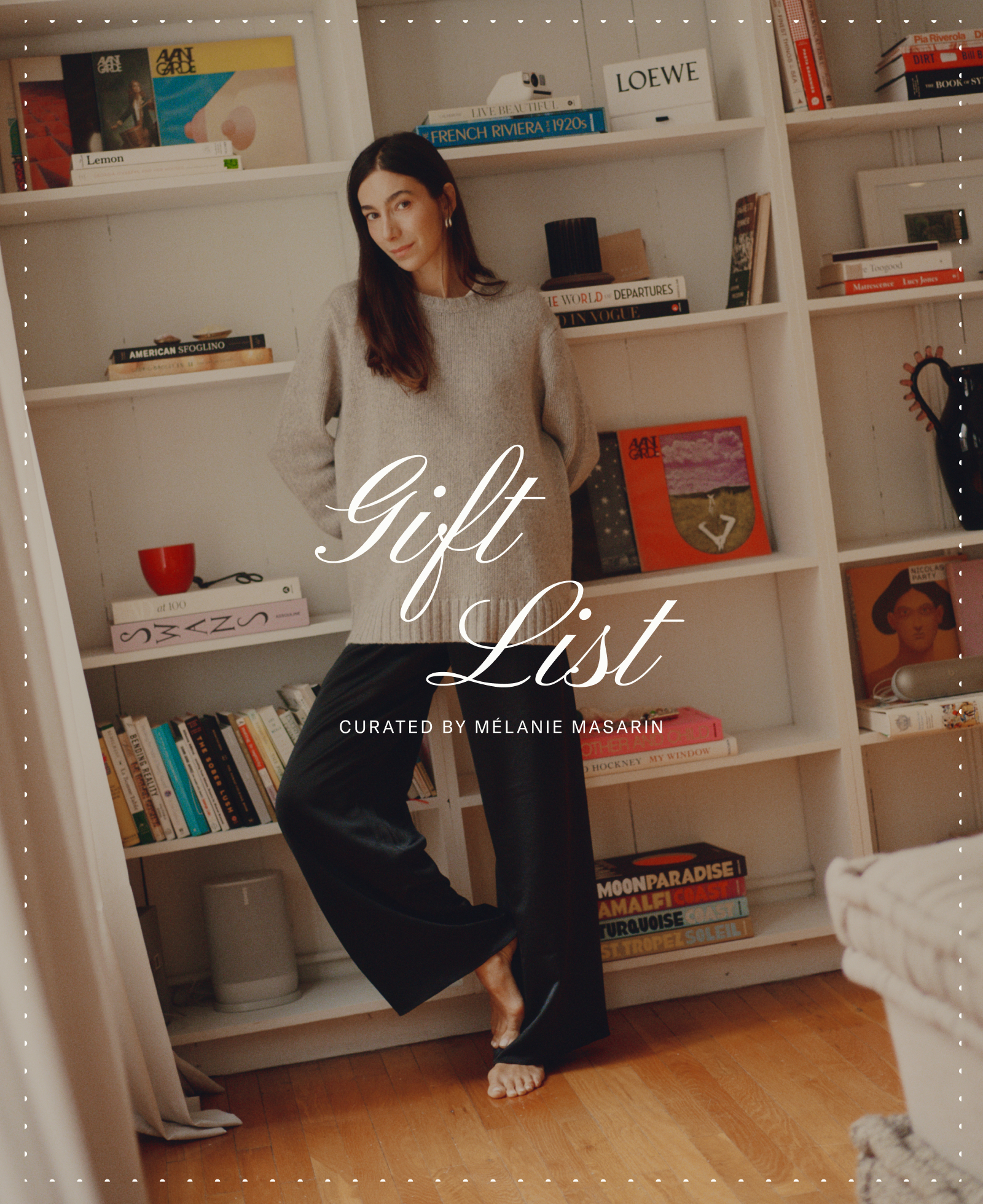 A woman in a cozy sweater and black pants stands in front of a bookshelf, one foot crossed over the other. Text overlay reads “Gift List curated by Melanie Masarin.” The bookshelf displays books and decorative items.