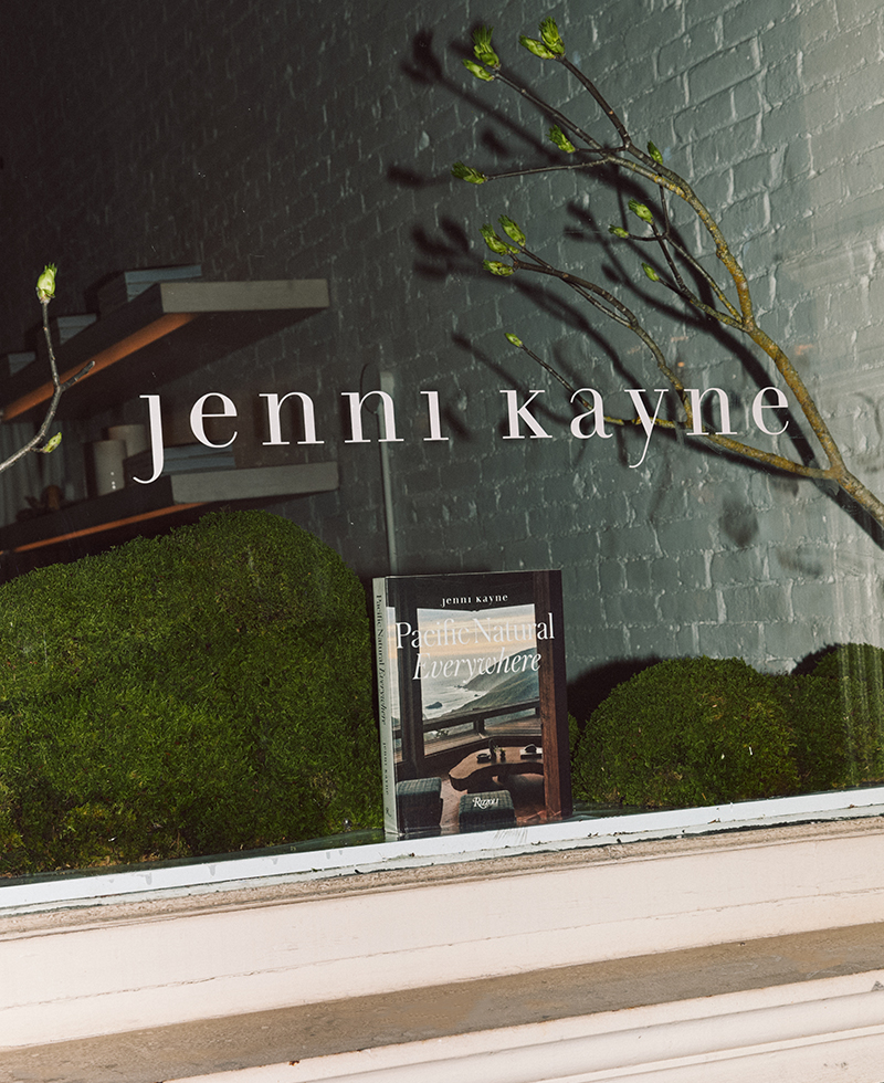 a storefront window with pacific natural everywhere book displayed with moss