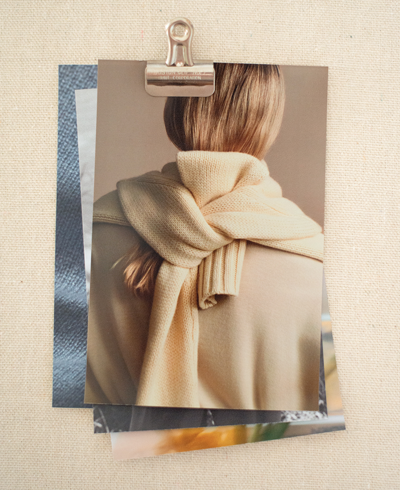 a pinboard with a photo of a woman wearing a yellow sweater tied around her back
