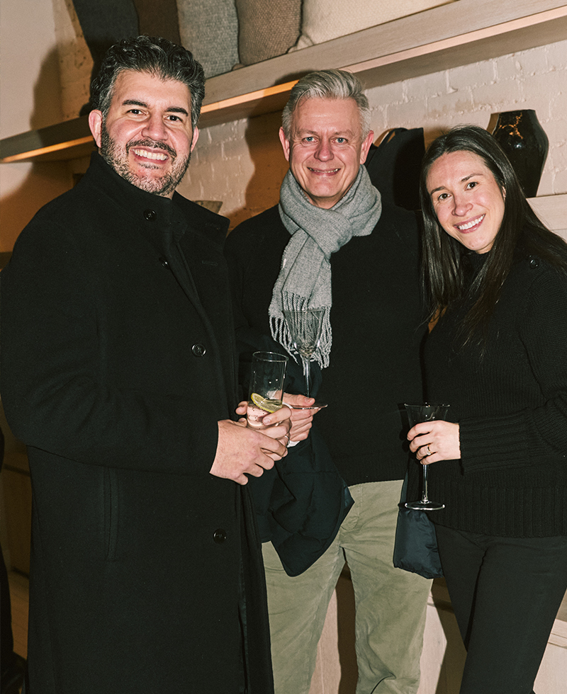 three guests posing at the event