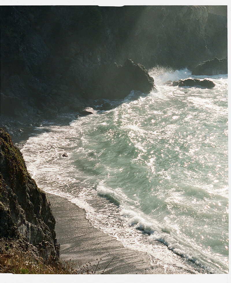 an ocean with cliffs